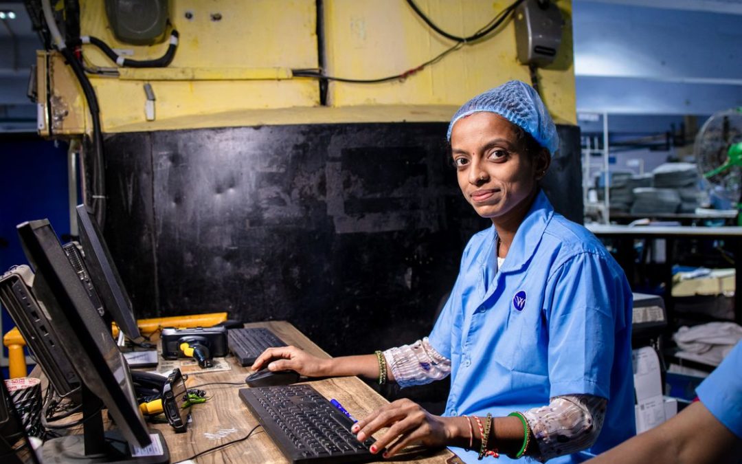 Factory operator at an industrial computer workstation representing ERP and MyInvois integration