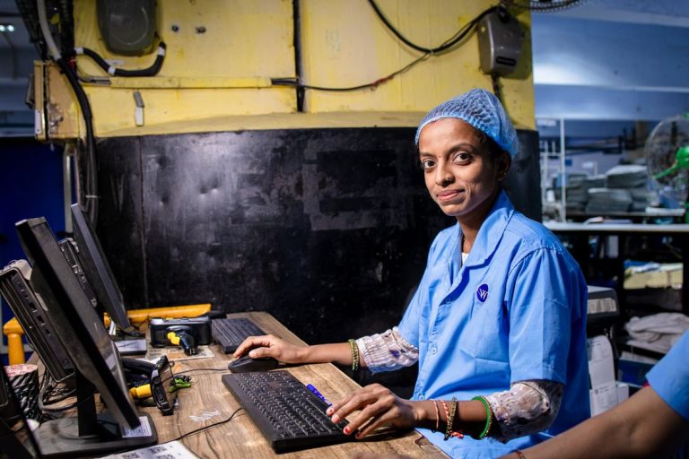 Factory operator at an industrial computer workstation representing ERP and MyInvois integration