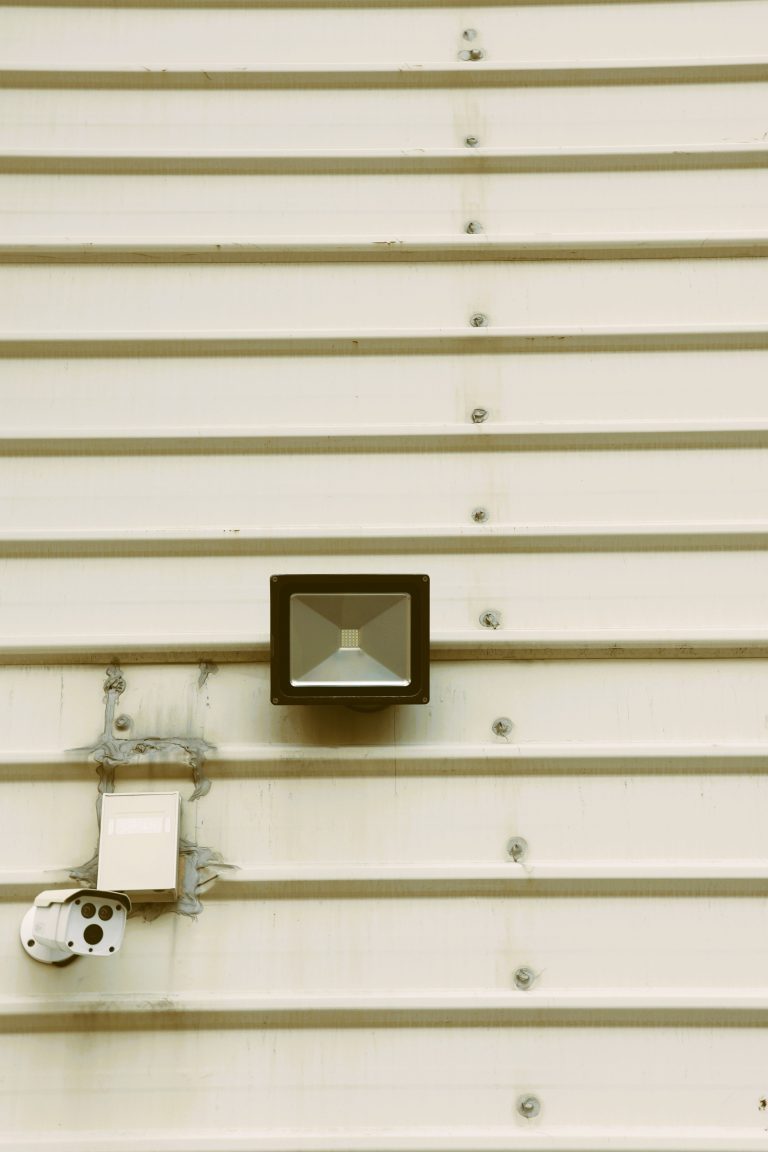 Industrial CCTV security camera installed on an industrial building, illustrating rugged surveillance requirements for factories
