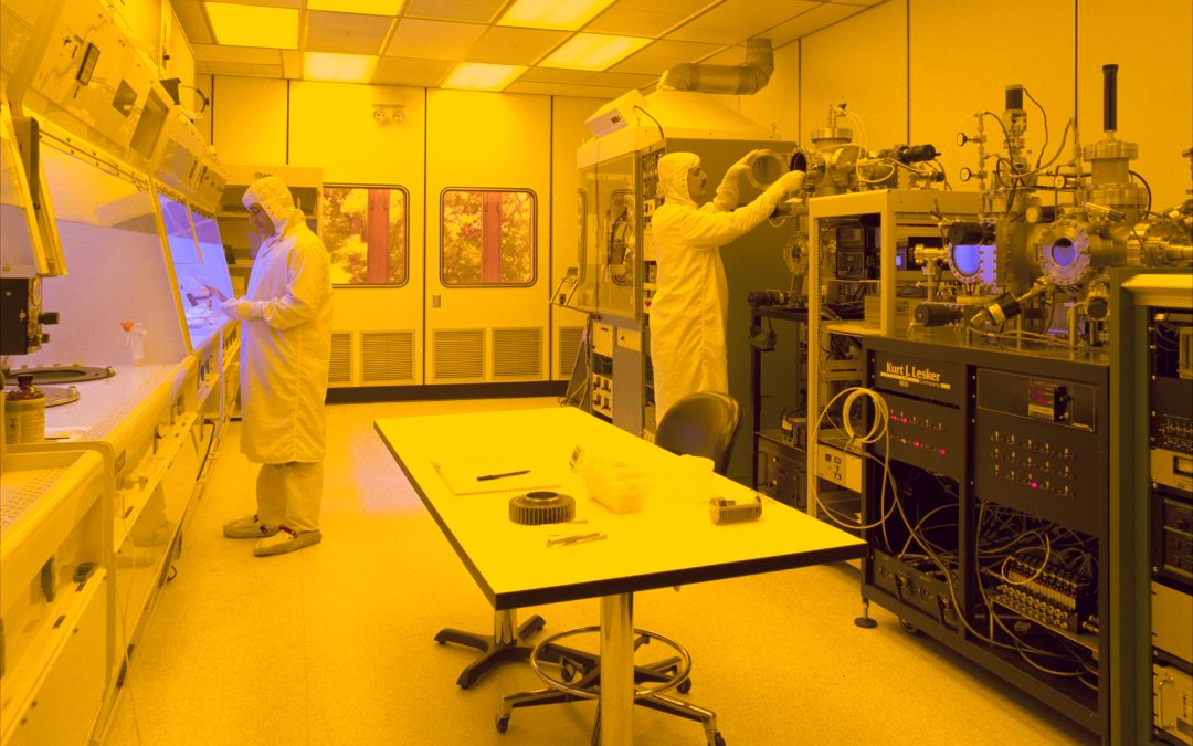 Semiconductor cleanroom manufacturing facility with engineers and process equipment