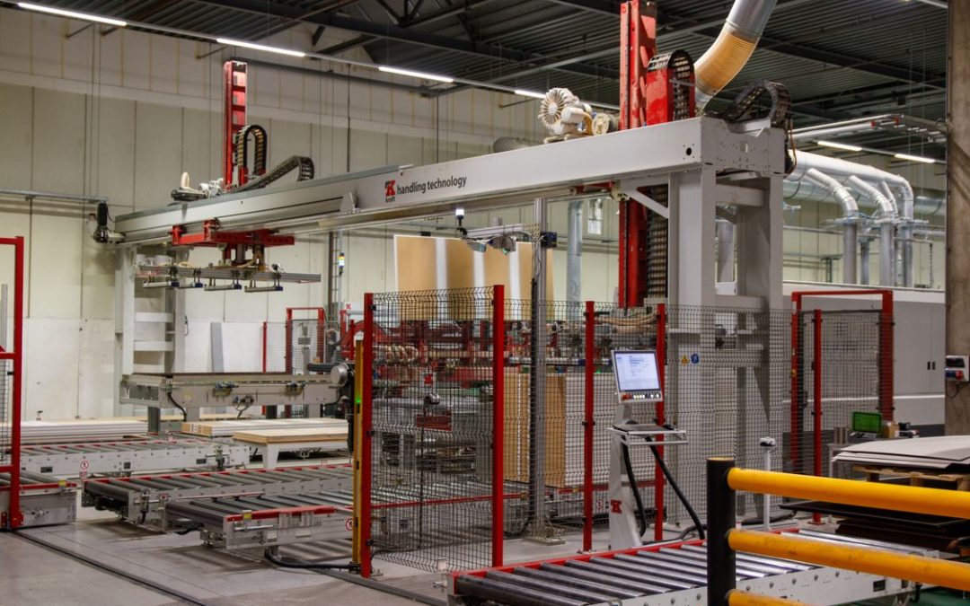 Industrial automated manufacturing system with robotic handling equipment and conveyors, illustrating physical AI and smart factory automation.