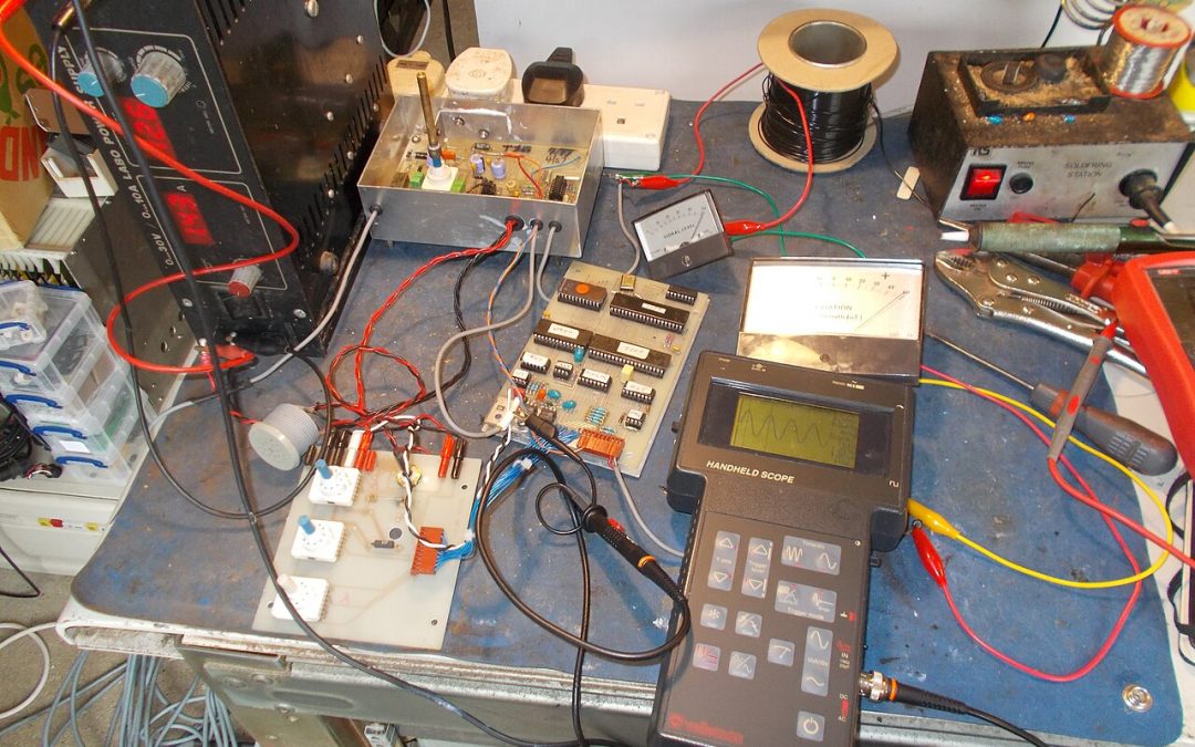 Electronics engineering test bench with circuit board and handheld measuring equipment; illustrative photograph by tony_duell, CC BY 2.0; not a PCAN device