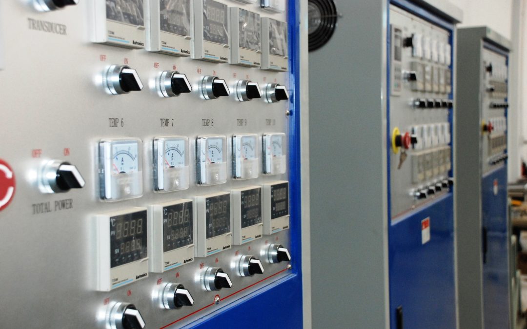 Industrial machine control cabinets with control instruments and operator switches; photograph by Poly-protech, CC BY-SA 4.0