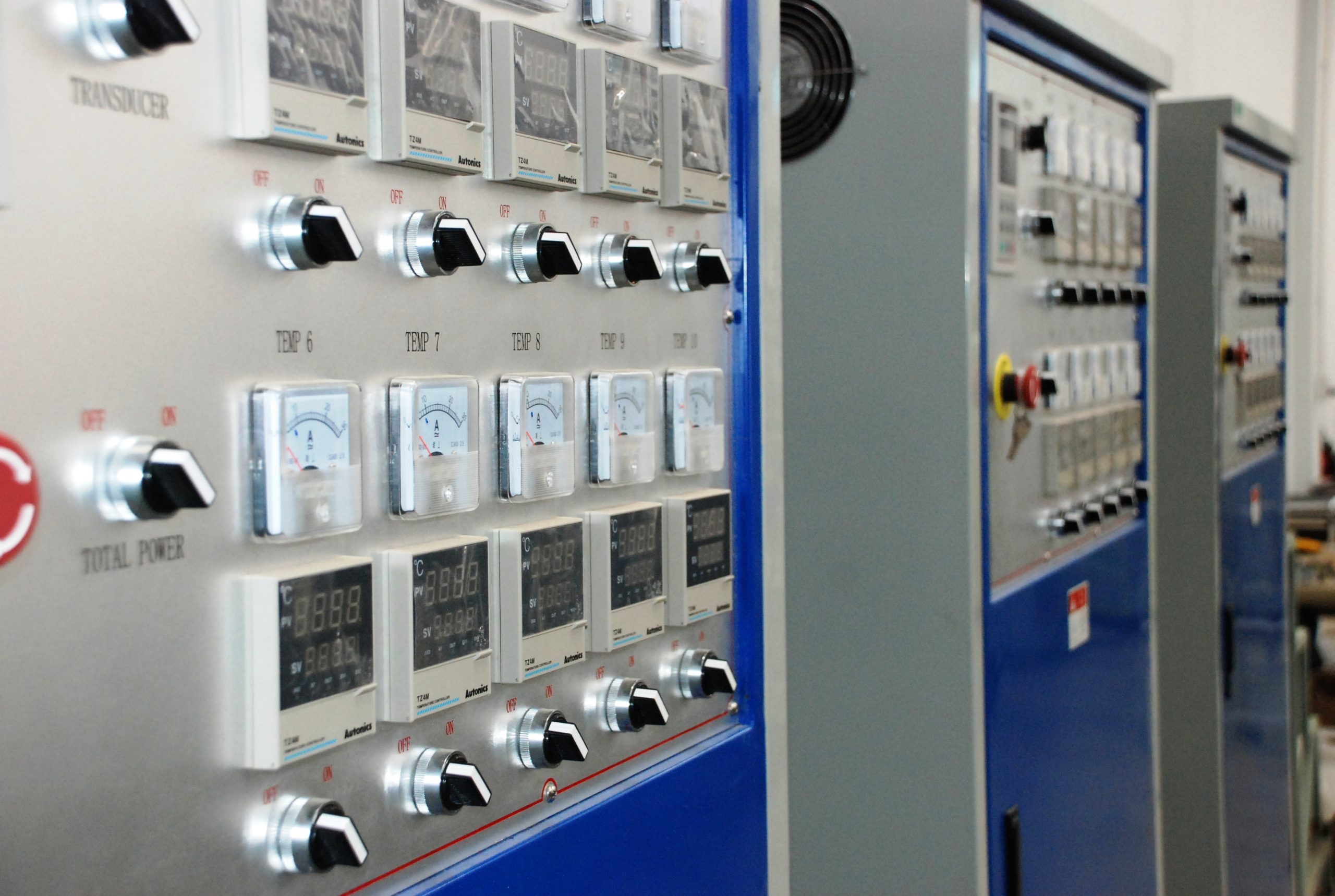 Industrial control cabinets with operator instruments and switches; illustrative photograph by Poly-protech, CC BY-SA 4.0