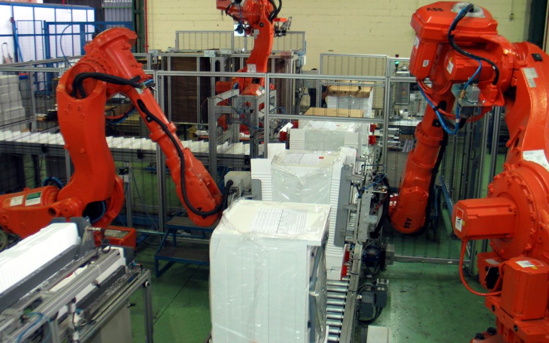 Industrial robots packaging products on a factory conveyor; illustrative image, not from PACK EXPO 2026