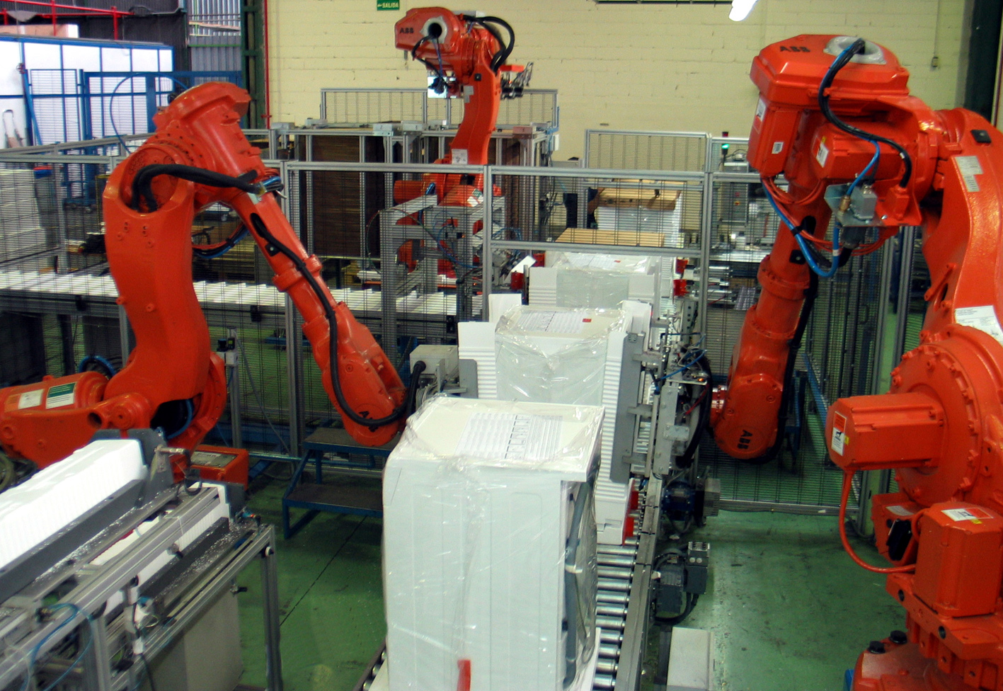 Industrial robots packaging products in a factory, illustrative photograph from 2013, not PACK EXPO 2026