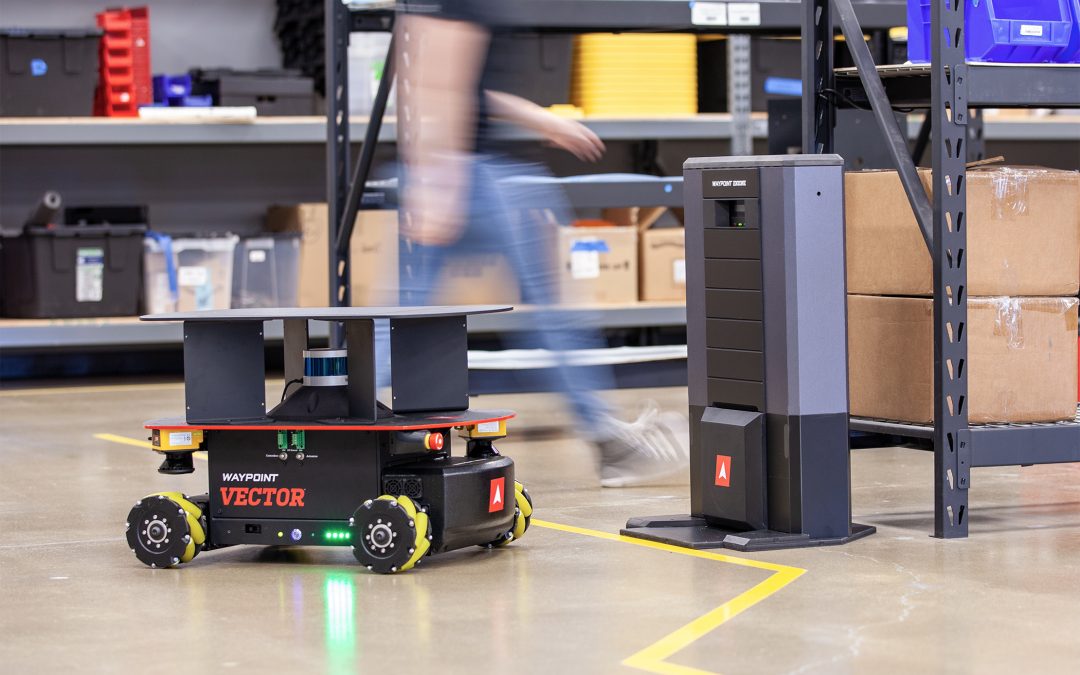Vector 3D HD autonomous mobile robot beside an EnZone charging station in a warehouse