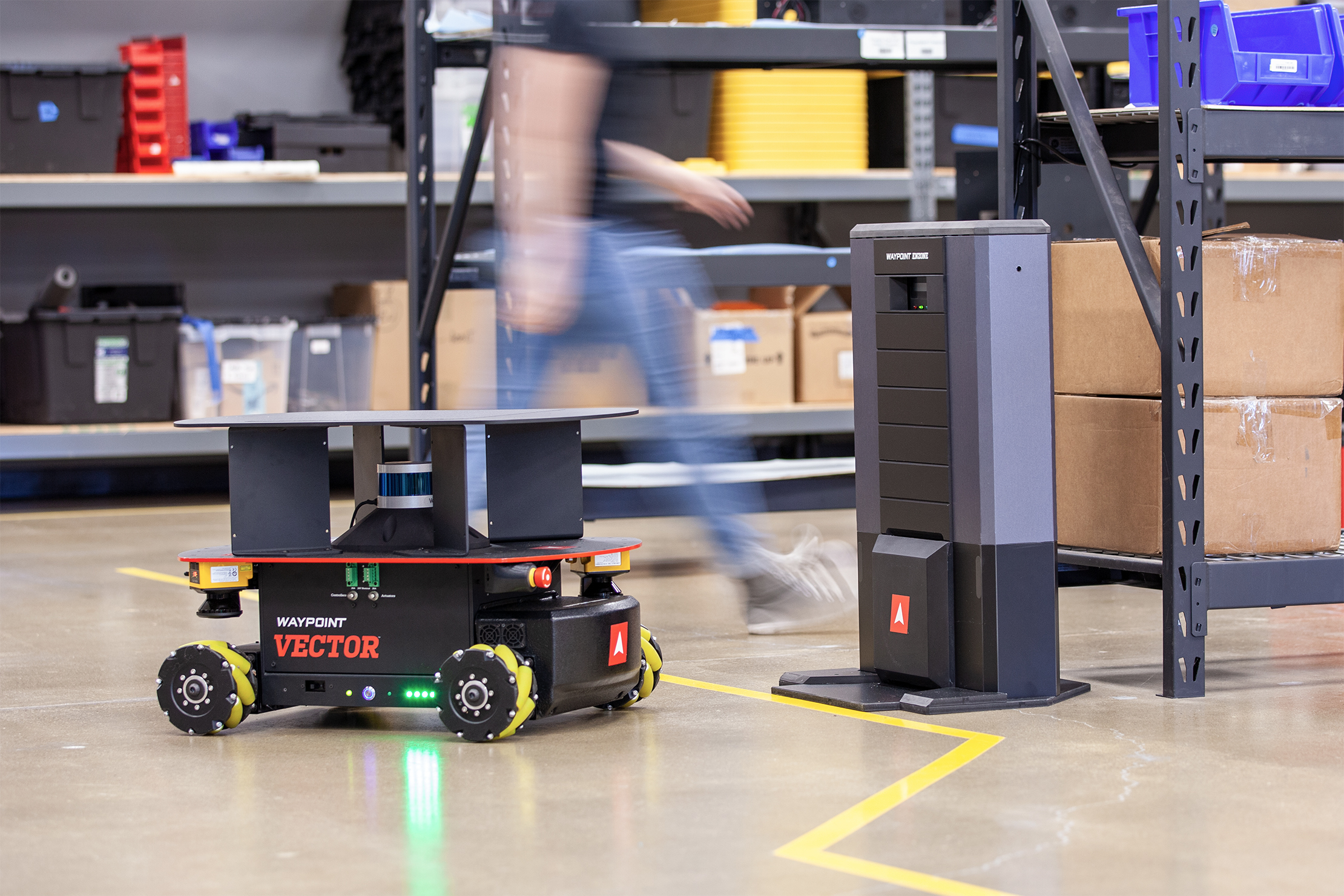 Vector 3D HD autonomous mobile robot beside an EnZone charging station in a warehouse