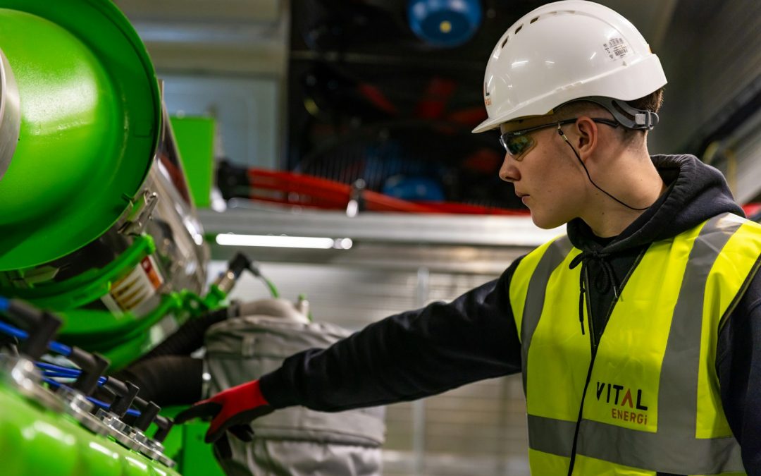 Industrial engineer working beside automated manufacturing equipment, representing Malaysia smart factory transformation