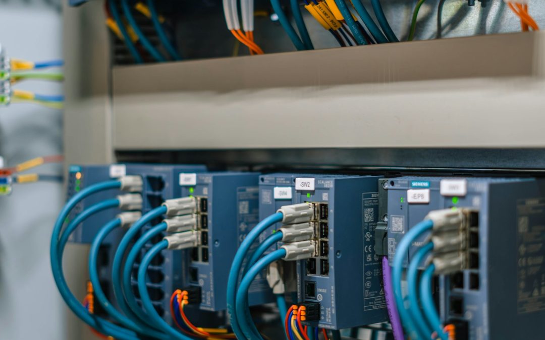 Industrial control panel with PLC modules and wiring, illustrating OT cybersecurity and factory ransomware risk