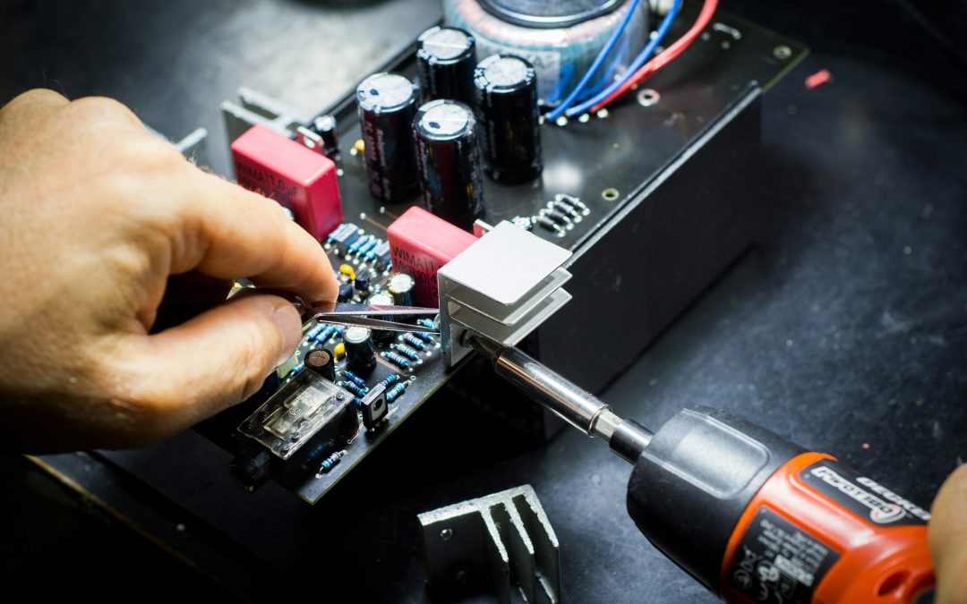 Technician working on a printed circuit board during manual electronics assembly
