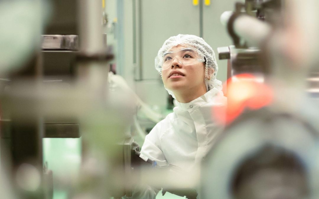 Biotechnologist inspecting large-scale equipment at Sanofi's Modulus Singapore biopharmaceutical manufacturing facility