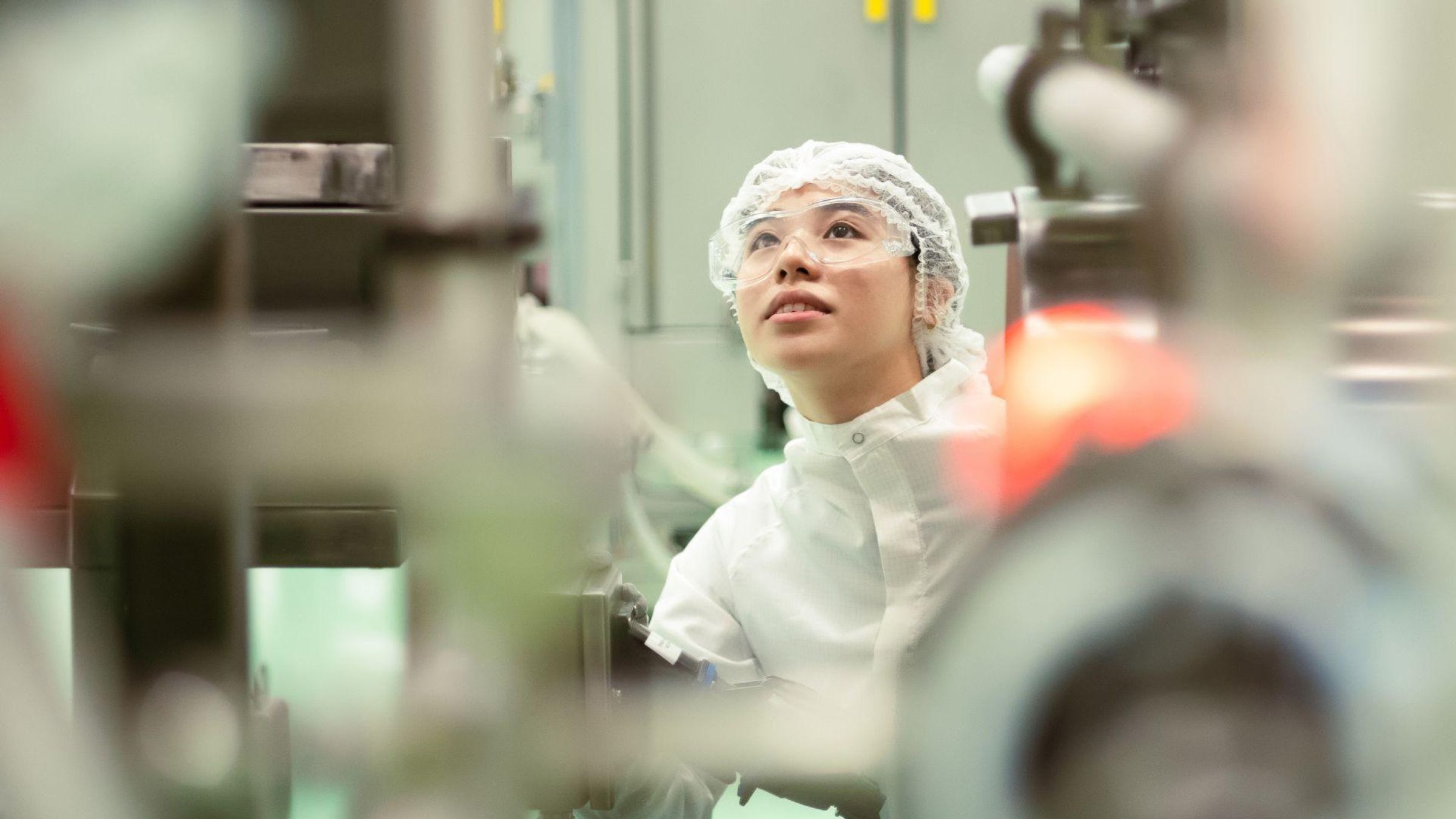 Biotechnologist inspecting large-scale equipment at Sanofi's Modulus Singapore biopharmaceutical manufacturing facility